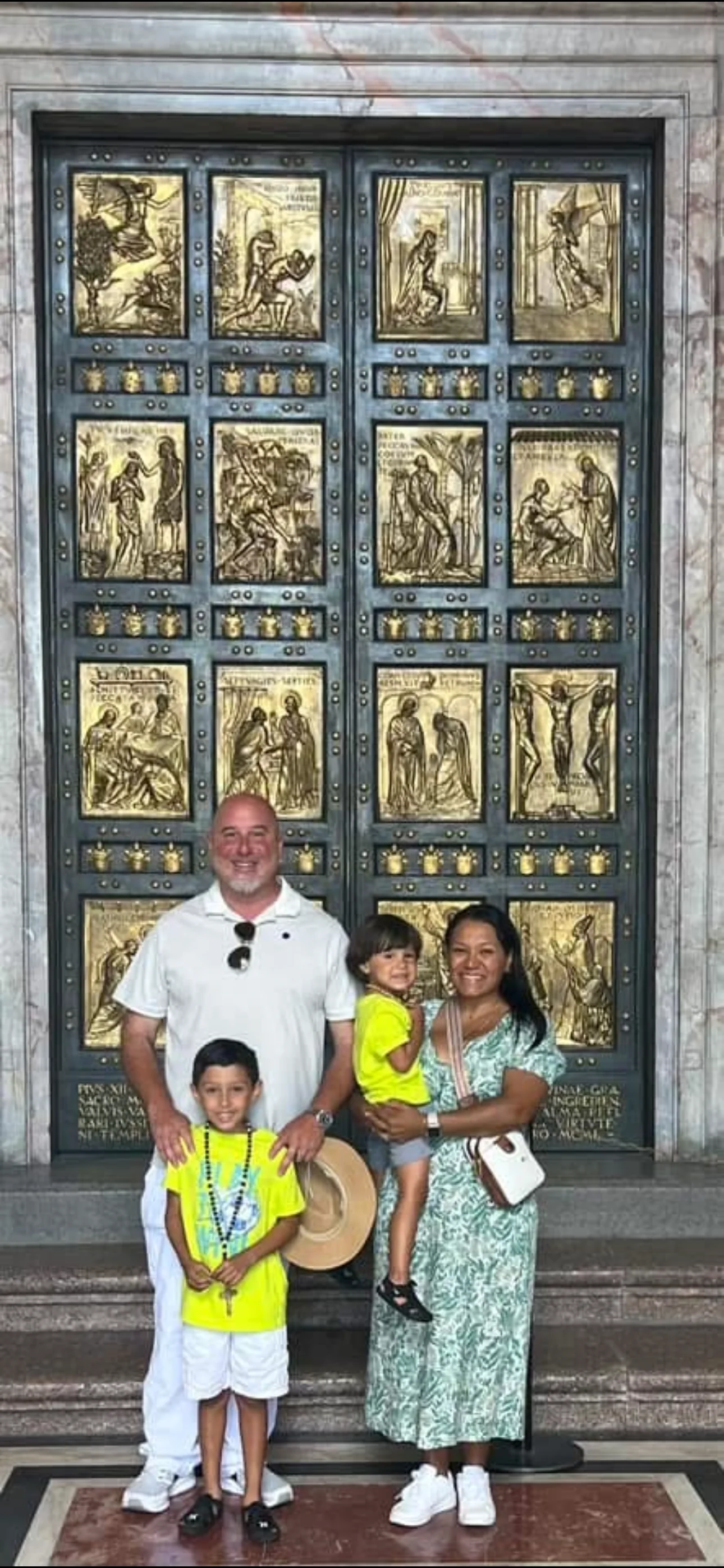 Andrew McGilly with his wife and two sons in front of the Holy Door of St. Peter's Basilica