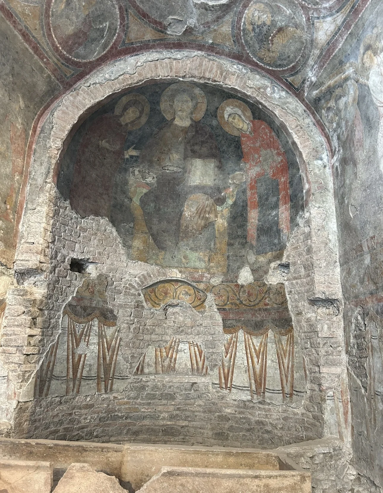 An early medieval fresco of Christ with saints in a ruined apse at Santa Maria Antiqua in the Roman Forum