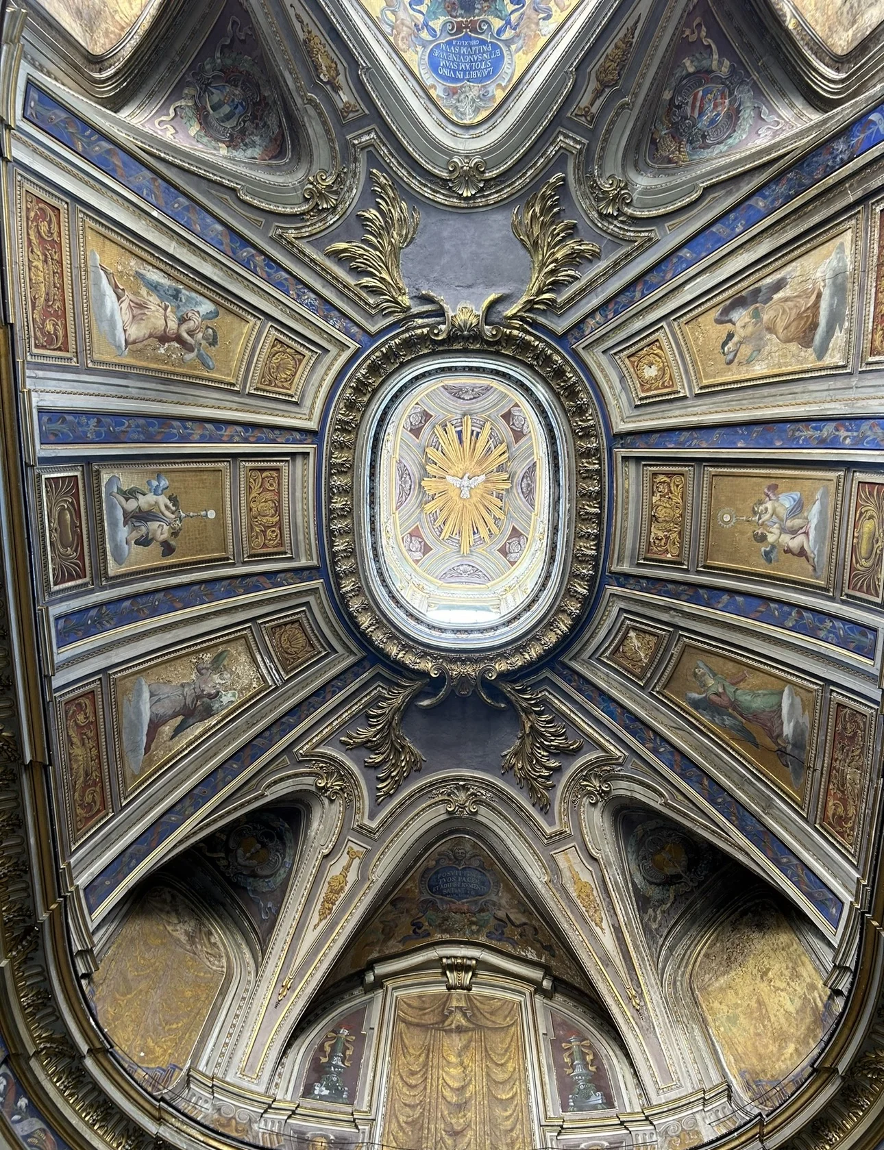 A painted and gilded vault in the Vatican Museums with the Holy Spirit in an oval at its center