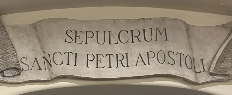 A marble scroll inscribed SEPULCRUM SANCTI PETRI APOSTOLI, the tomb of St. Peter the Apostle, in the Vatican Grottoes
